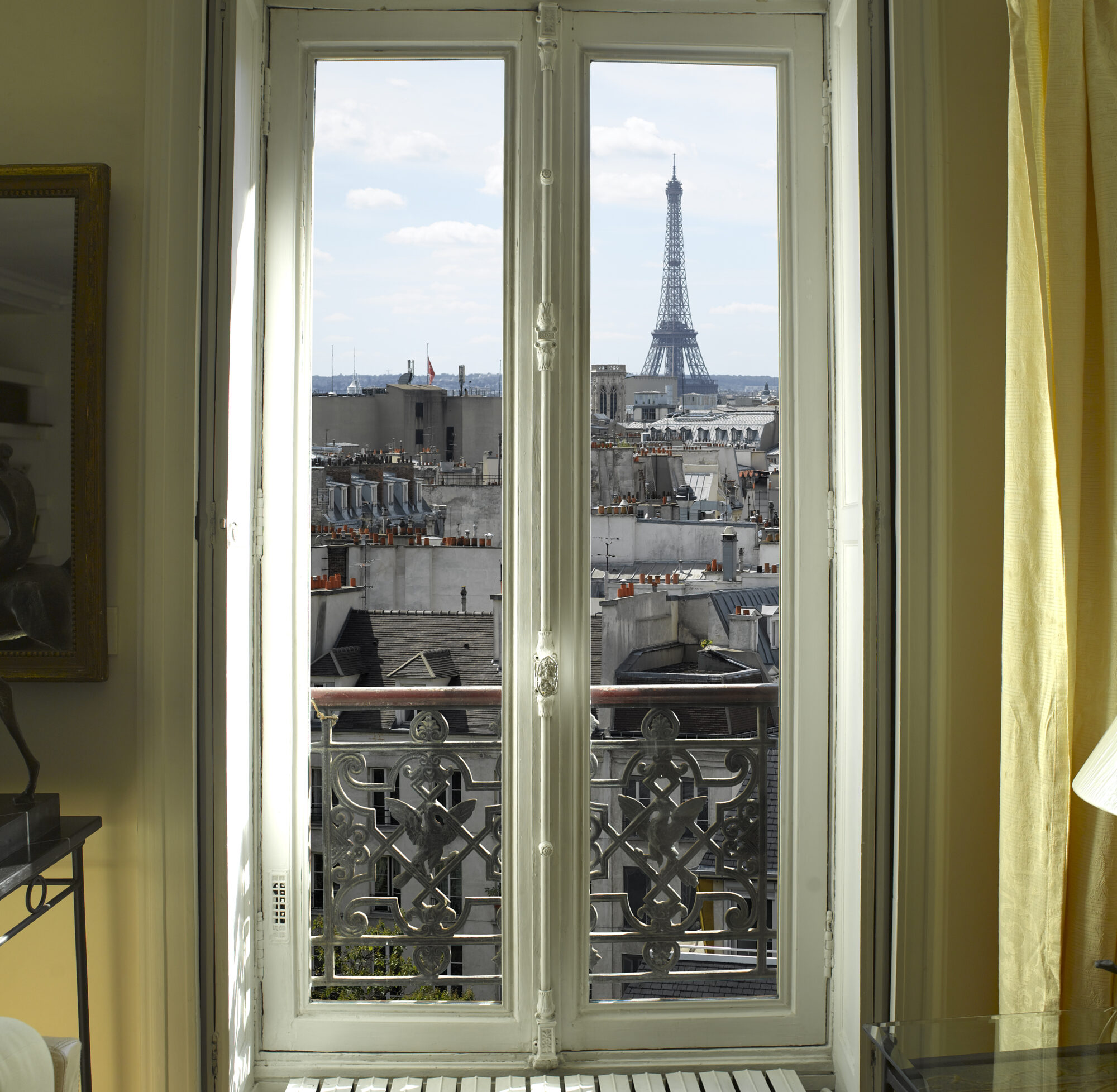 france paris window with eiffel tower and roofs view